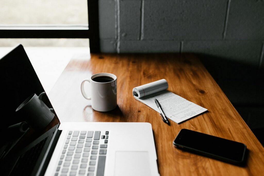 Open notebook and laptop on a writing desk