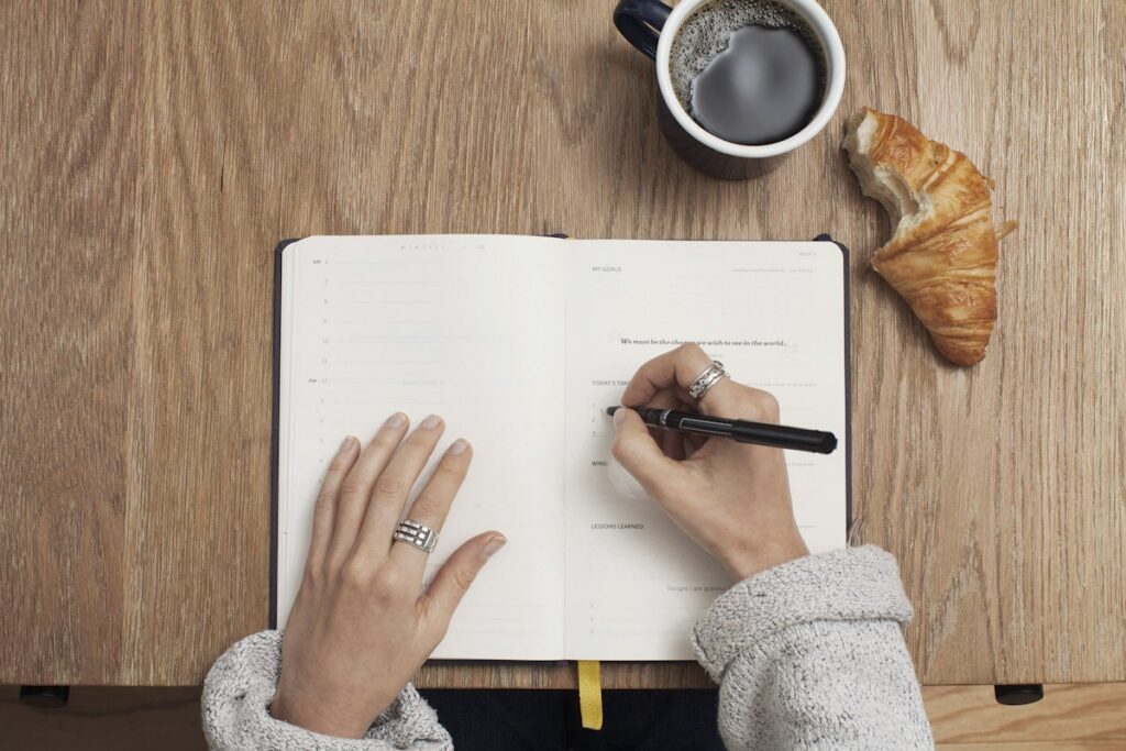 Open notebook and writing tools on a desk